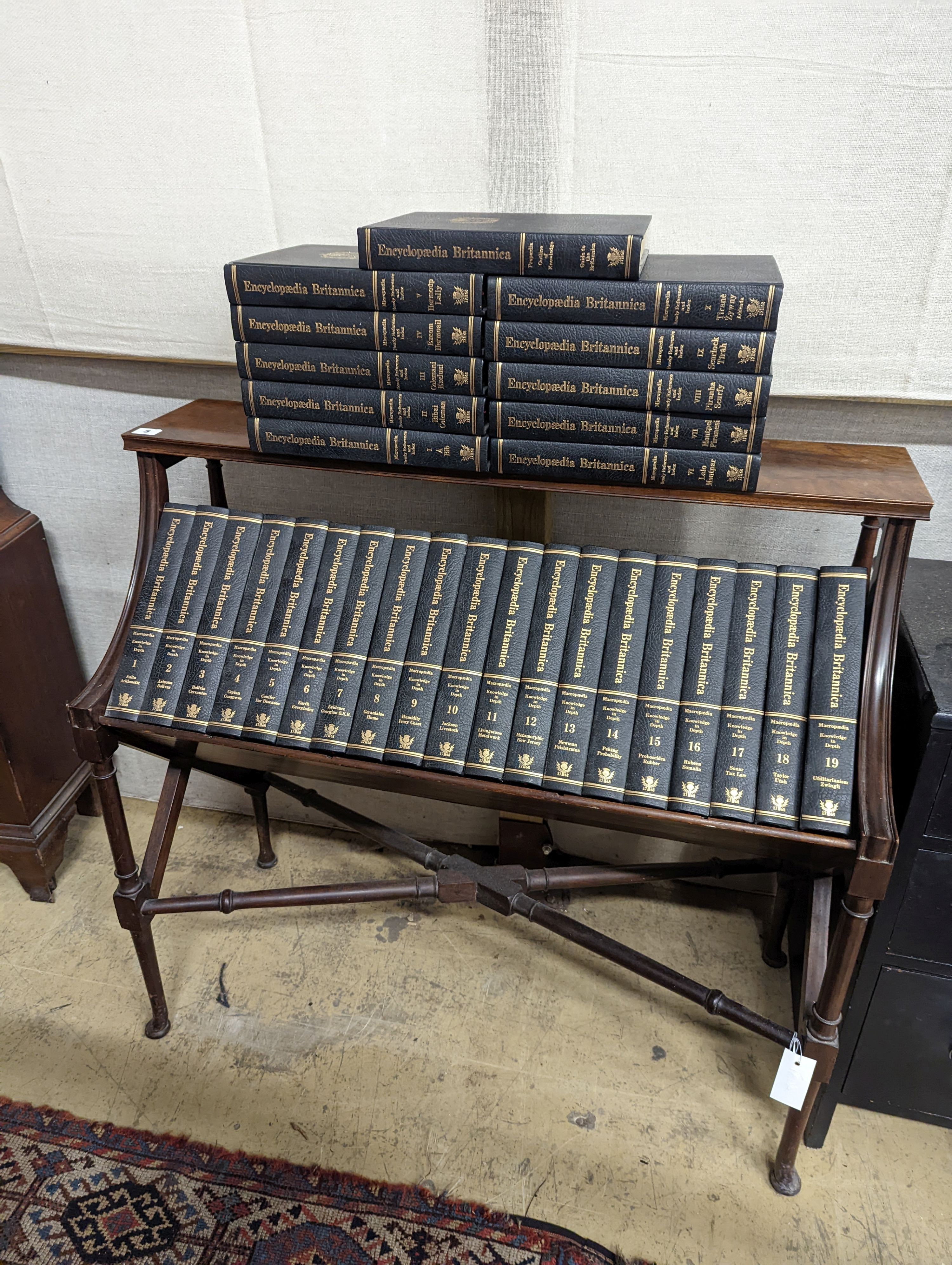 A Liberty style mahogany book stand, together with a set of the Encyclopedia Britannica, width 91cm, depth 39cm, height 84cm
